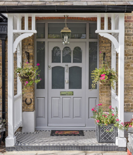 an impressive front door with sidelights and etched glass