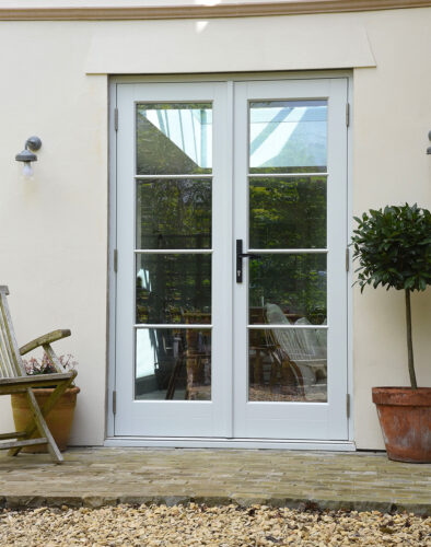 timeless french doors on a rendered building with horizontal glazing bars