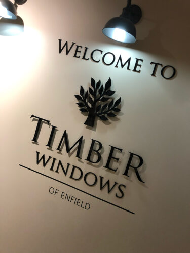 timber windows signage on a white wall