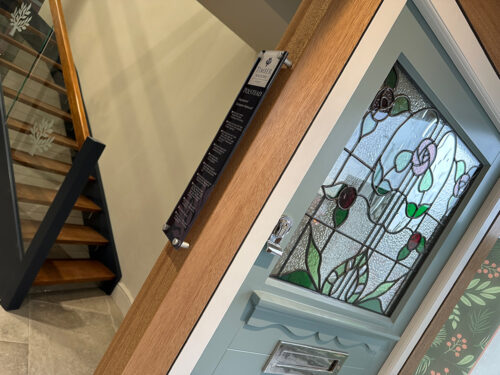 a front door with stained glass on display in a showroom