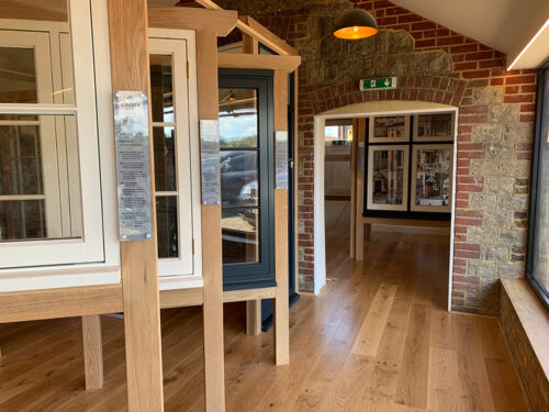 a selection of windows on display in a barn type building