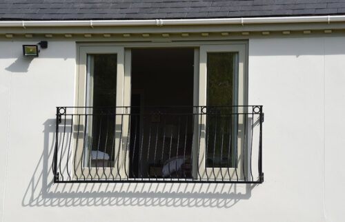 a set of open patio doors on a juliet balcony