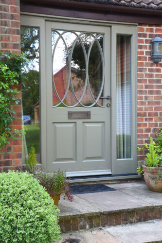 a front door with a spiral style glazing bar pattern