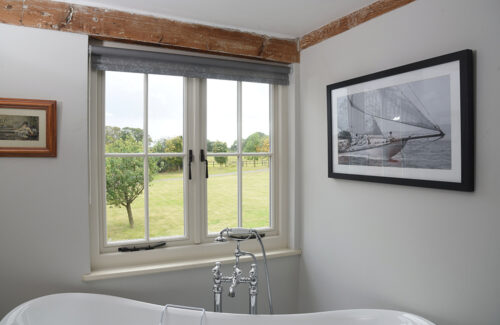 a set of casement windows in a country home bathroom