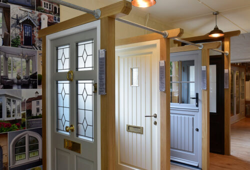 4 front doors on display in a showroom