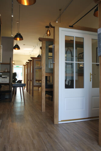 a dark windows and doors showroom with a set of french doors in front