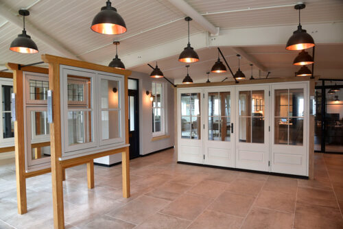 a selection of timber windows and french doors on display in cirencester