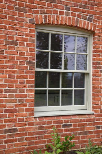 a traditional georgian box sash window on a red brick property