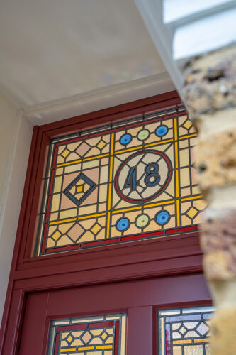 a front door toplight with bespoke ornate stained glass