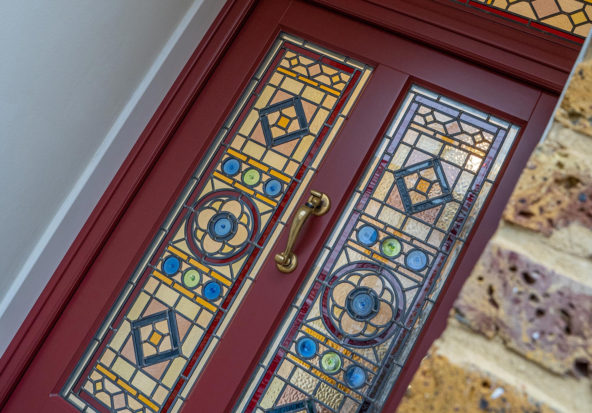 a red front door with bespoke stained glass