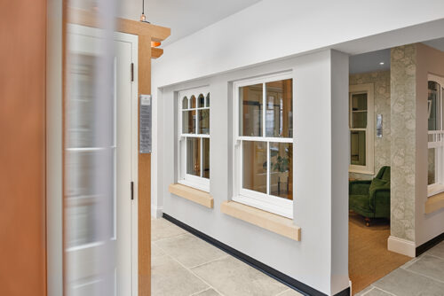 2 timber sash windows on display in a showroom