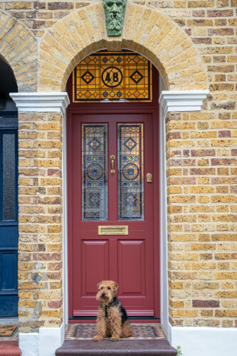 a red front door with bespoke stained glass