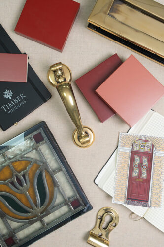 various different door elements, such as hardware and glass, laid out on a table