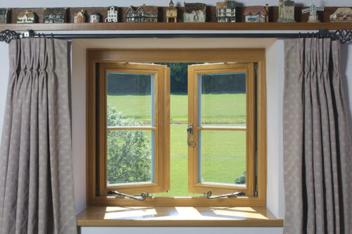 an open oak stained casement window