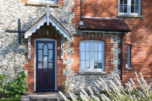 a gothic front door and casement on a traditional stone property