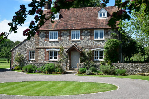 a beautiful stone property with white windows
