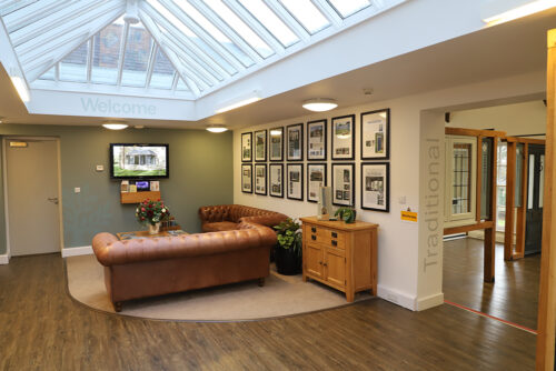 a seating area with multiple framed images hanging on the wall