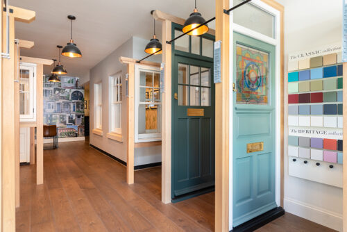 timber windows and front doors on display in a showroom