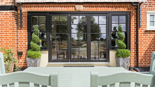 a set of black bifold doors with sash flag windows