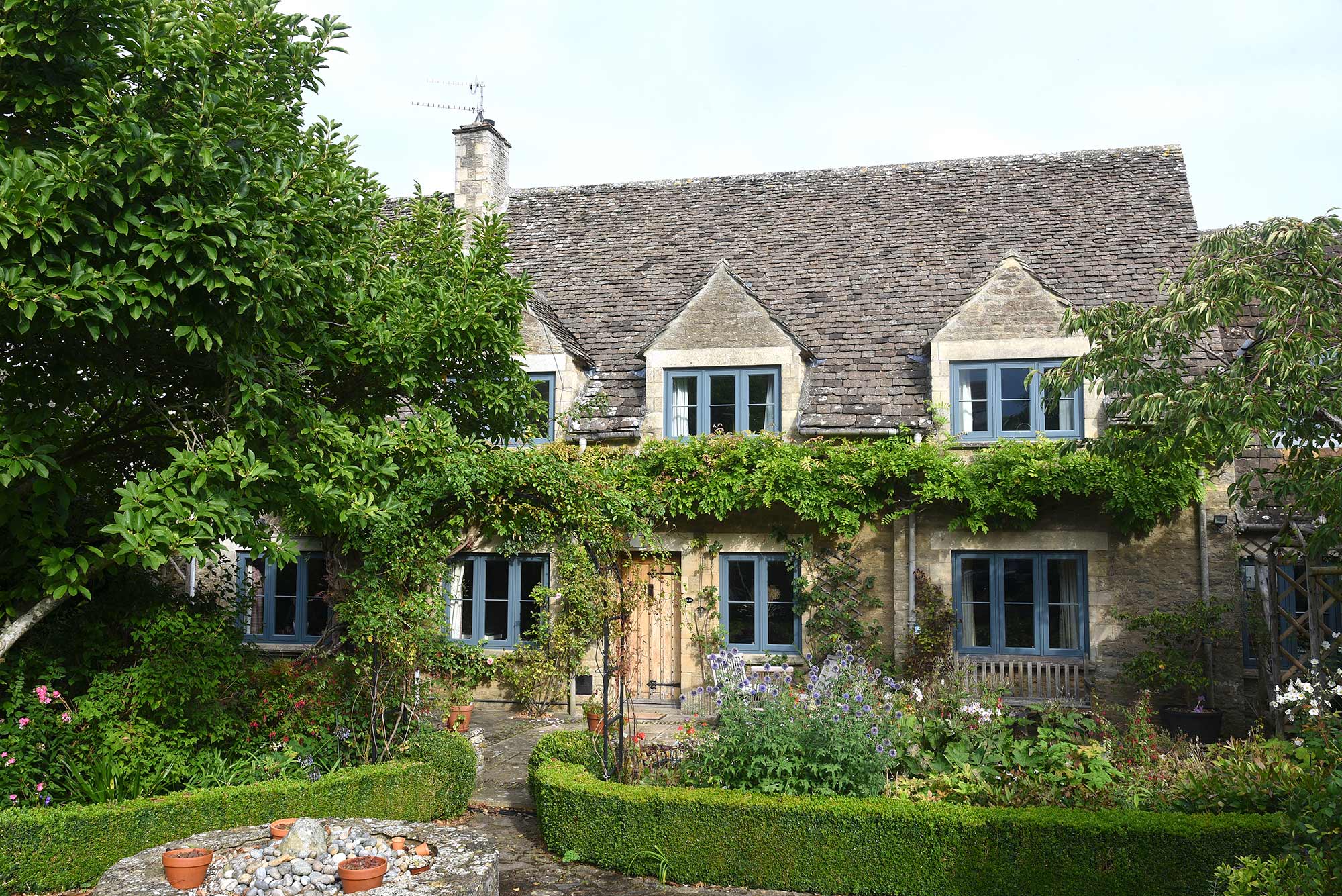 a beautiful cotswolds cottage with blue casement windows