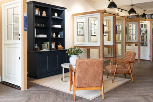 a row of casement windows and doors on display in a showroom