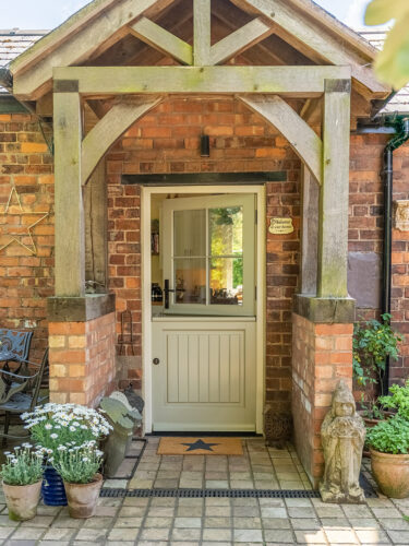 a charming stable door under a beautiful oak canopy