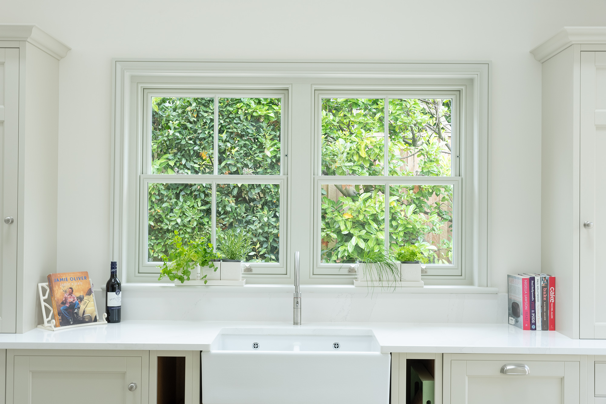 two spring sash windows behind a butler sink in a contemporary styled kitchen