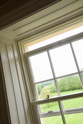 a partially open spring sash timber window